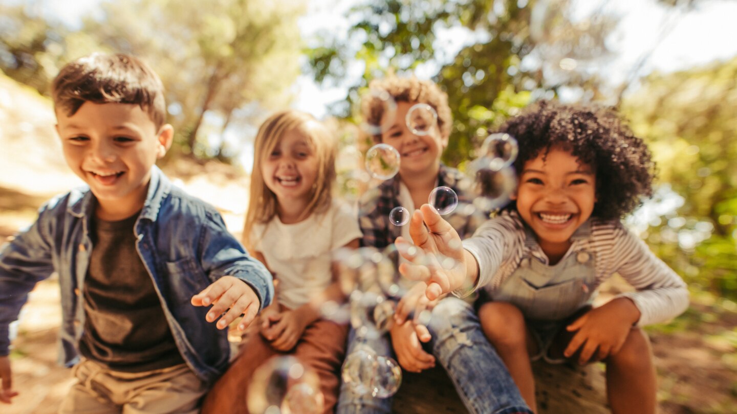 Group of children playing with soap bubbles