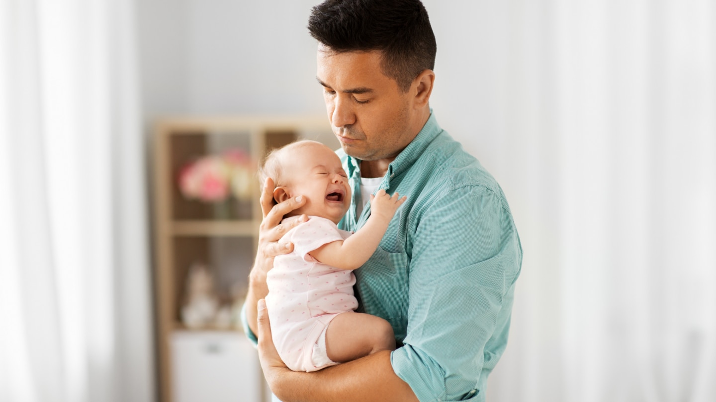 father comforting little baby
