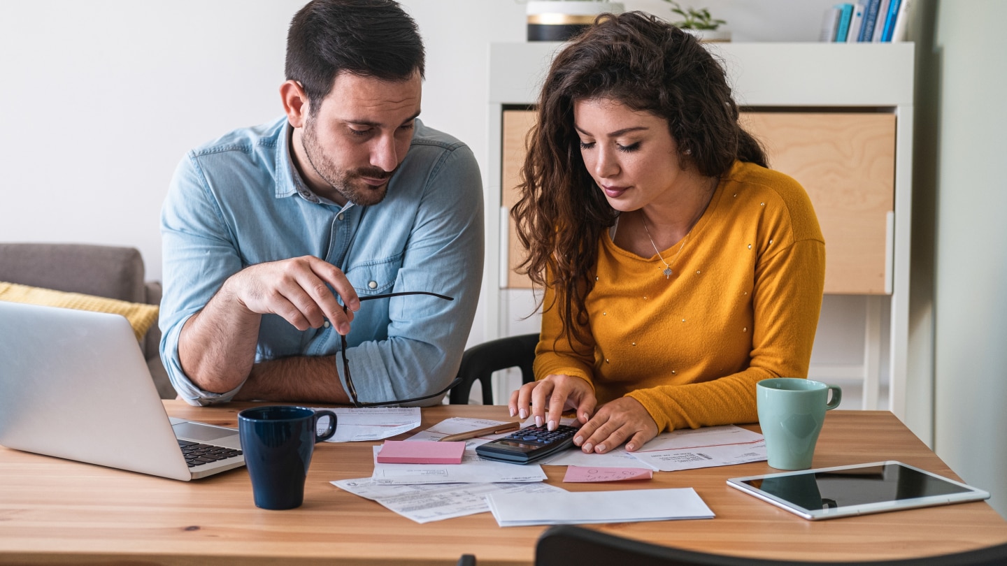 Young couple calculating their domestic bills