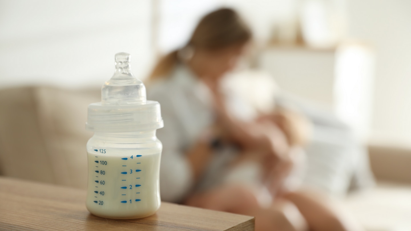 Mother breastfeeding her little baby at home