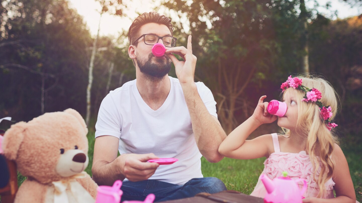 daughter and father having a tea party