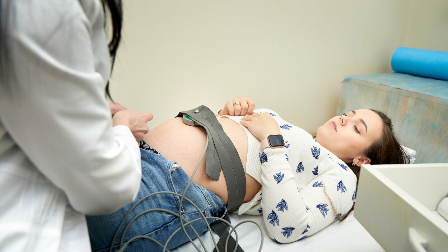 pregnant female visiting her own gynecologist in medical clinic