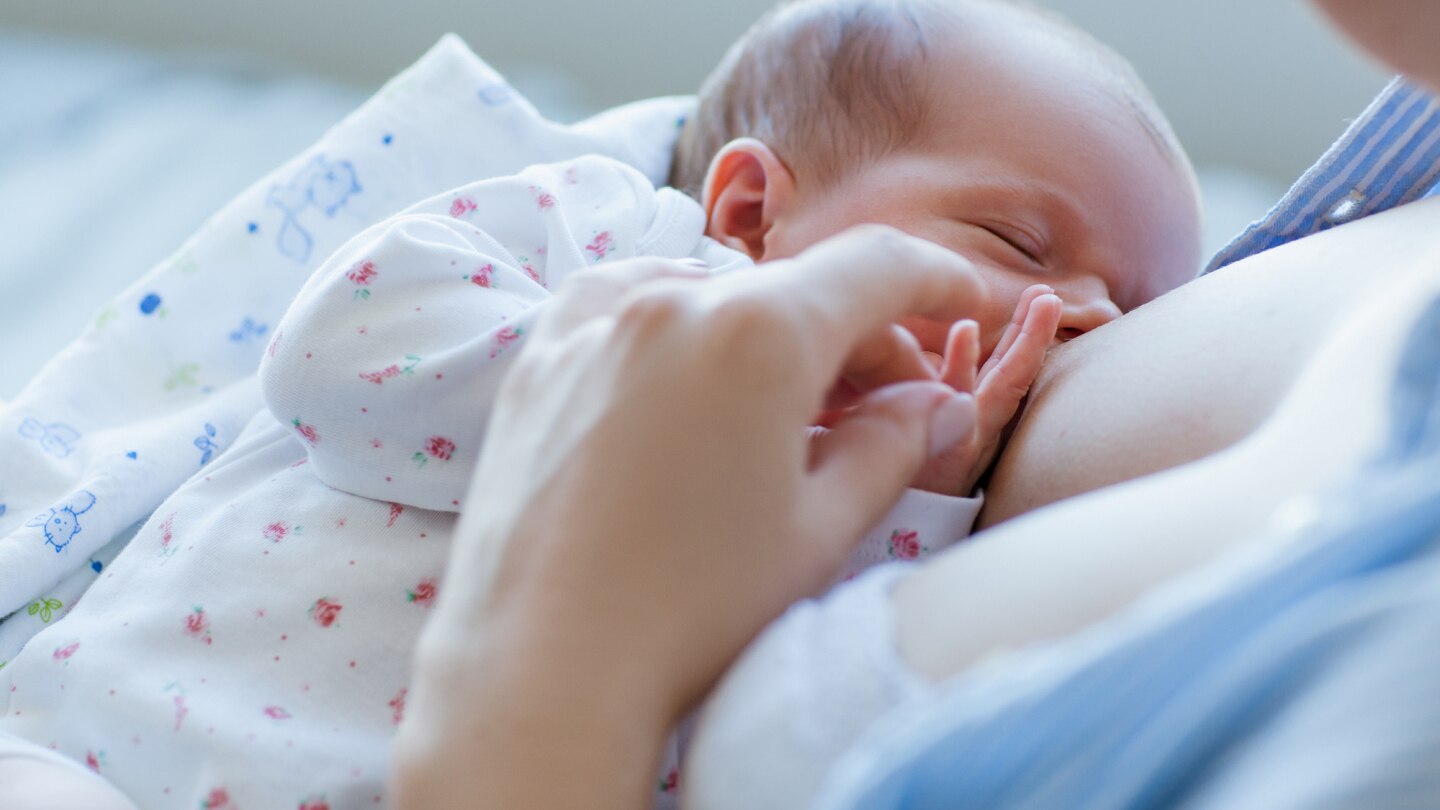 baby saugt an der Brust von der Mutter