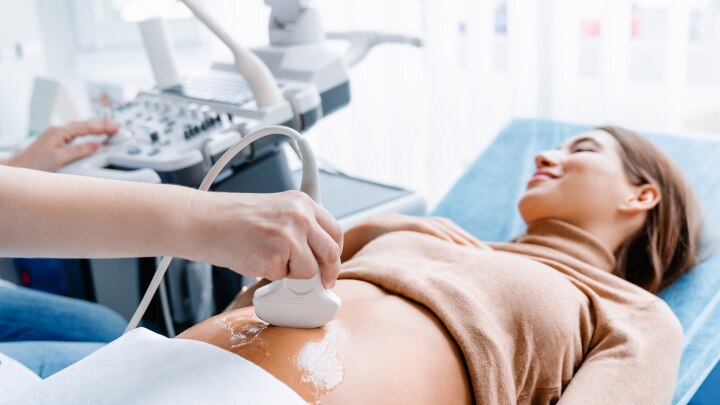 Doctor hand with ultrasonic during ultrasound medicine examination of pregnant patient