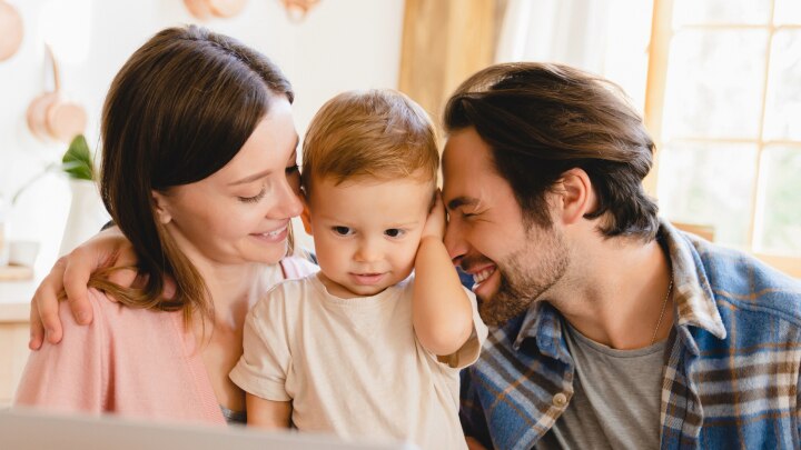 mama und papa umarmen ihr kleinkind