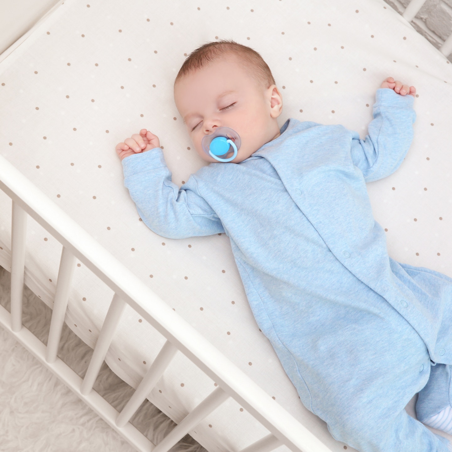 Cute little baby sleeping in cradle at home