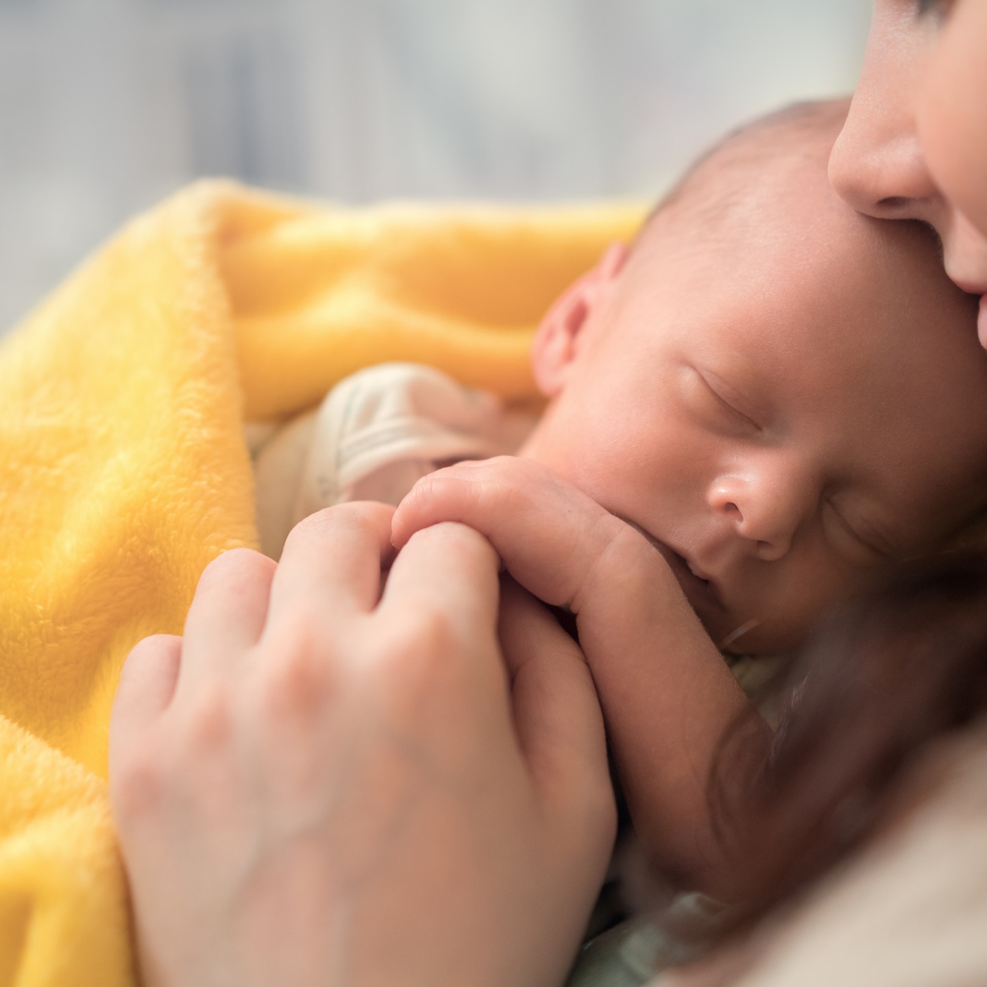 woman holding a newborn baby in her arms
