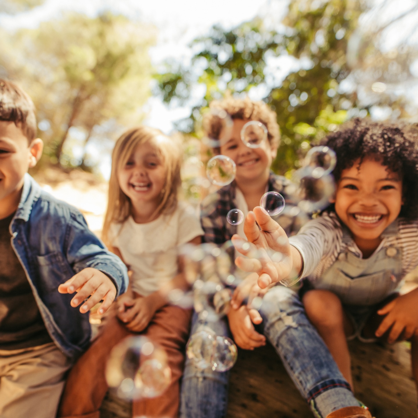 Group of children playing with soap bubbles
