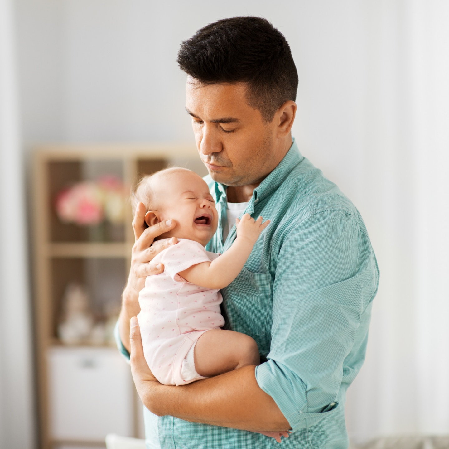 father comforting little baby