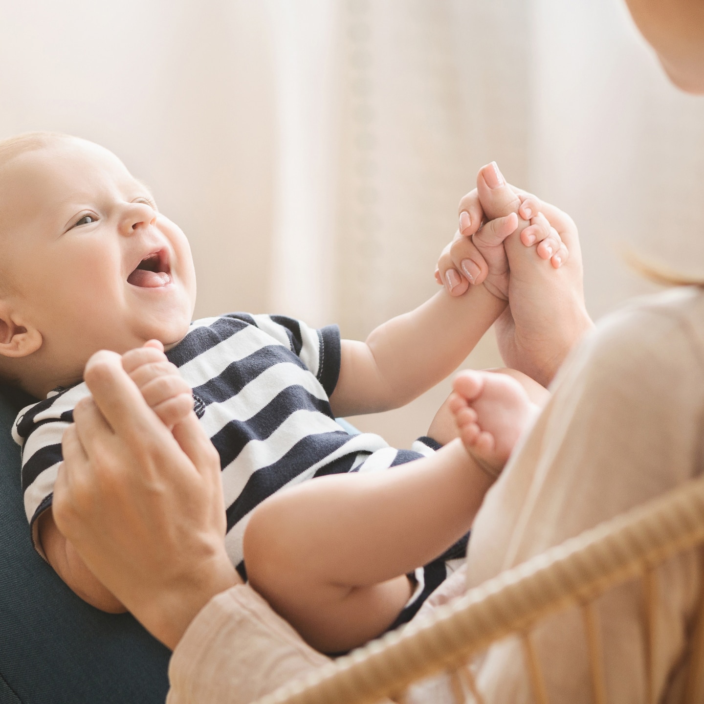 Portrait of sweet newborn child lying on mom's lap
