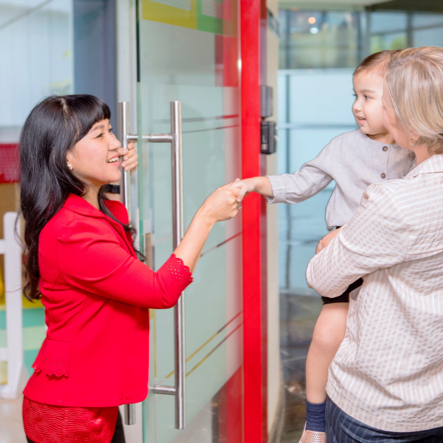 Little girl shaking hands with her teacher