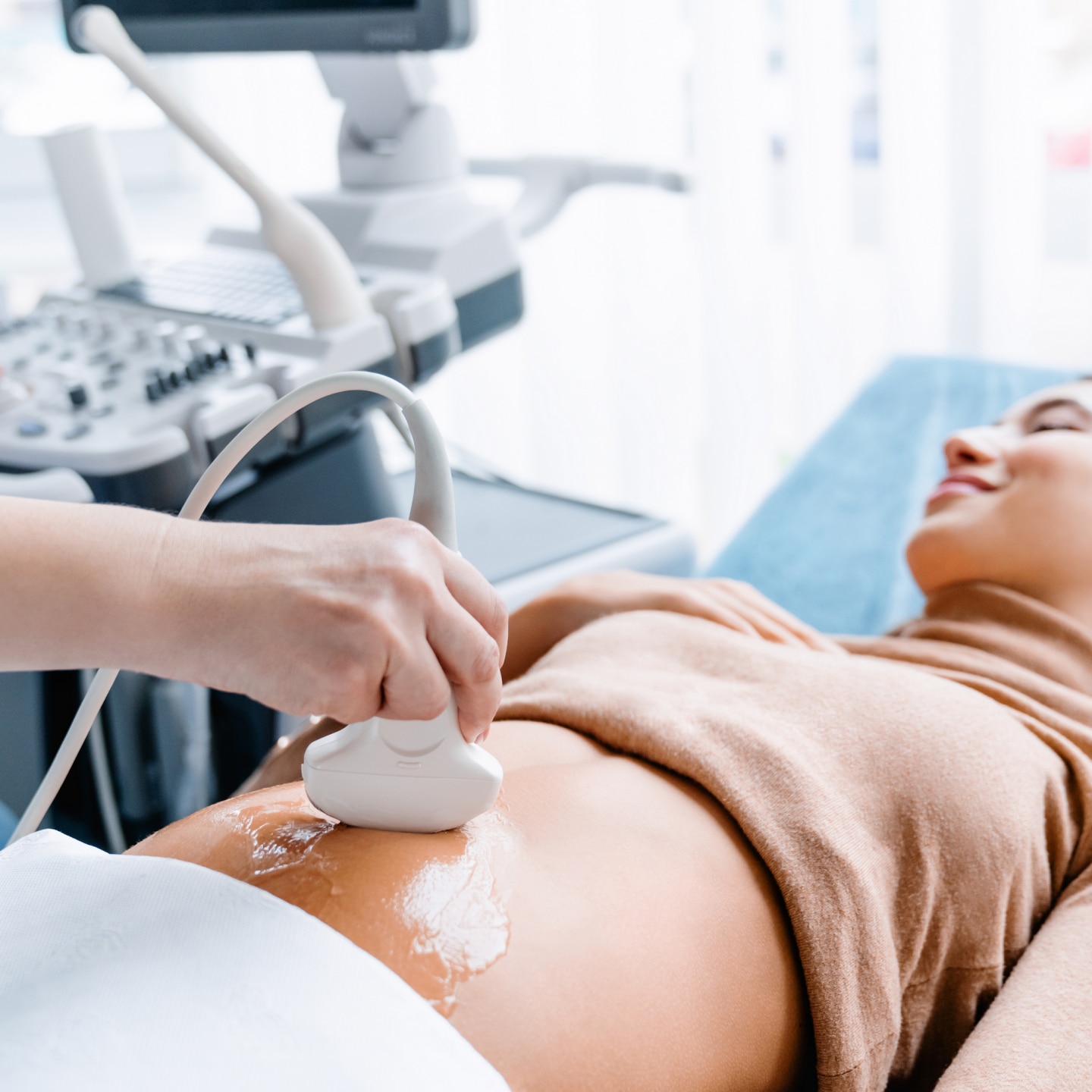 Doctor hand with ultrasonic during ultrasound medicine examination of pregnant patient