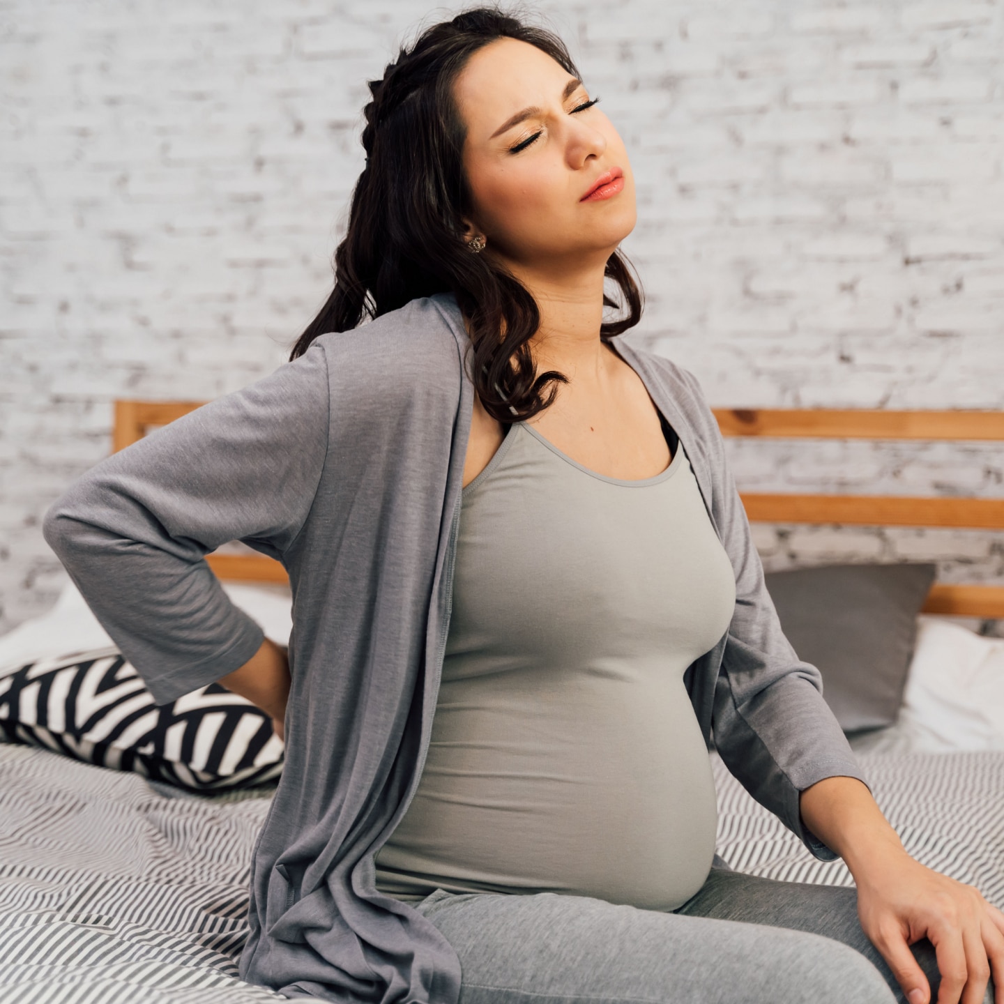 Asian mixed Caucasian pregnant woman suffering back pain