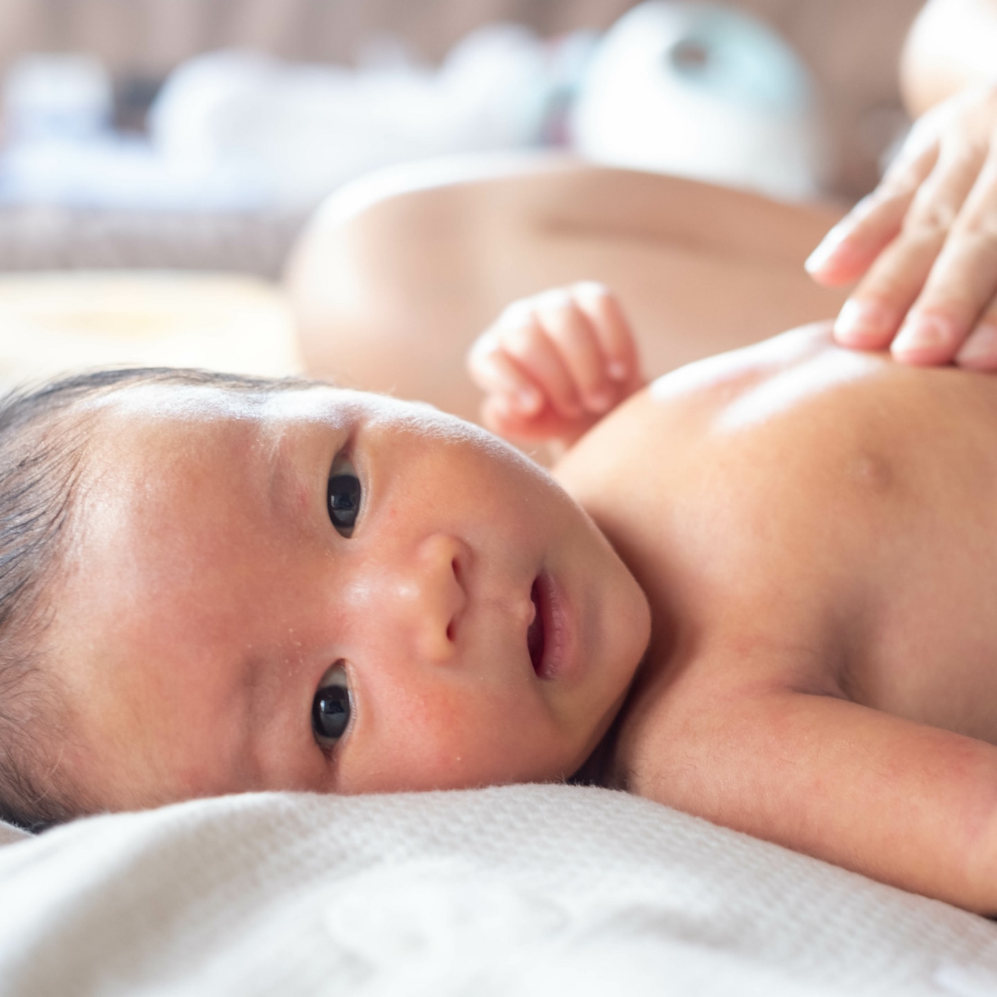 Close-up hands of mother touching and take care newborn infant baby