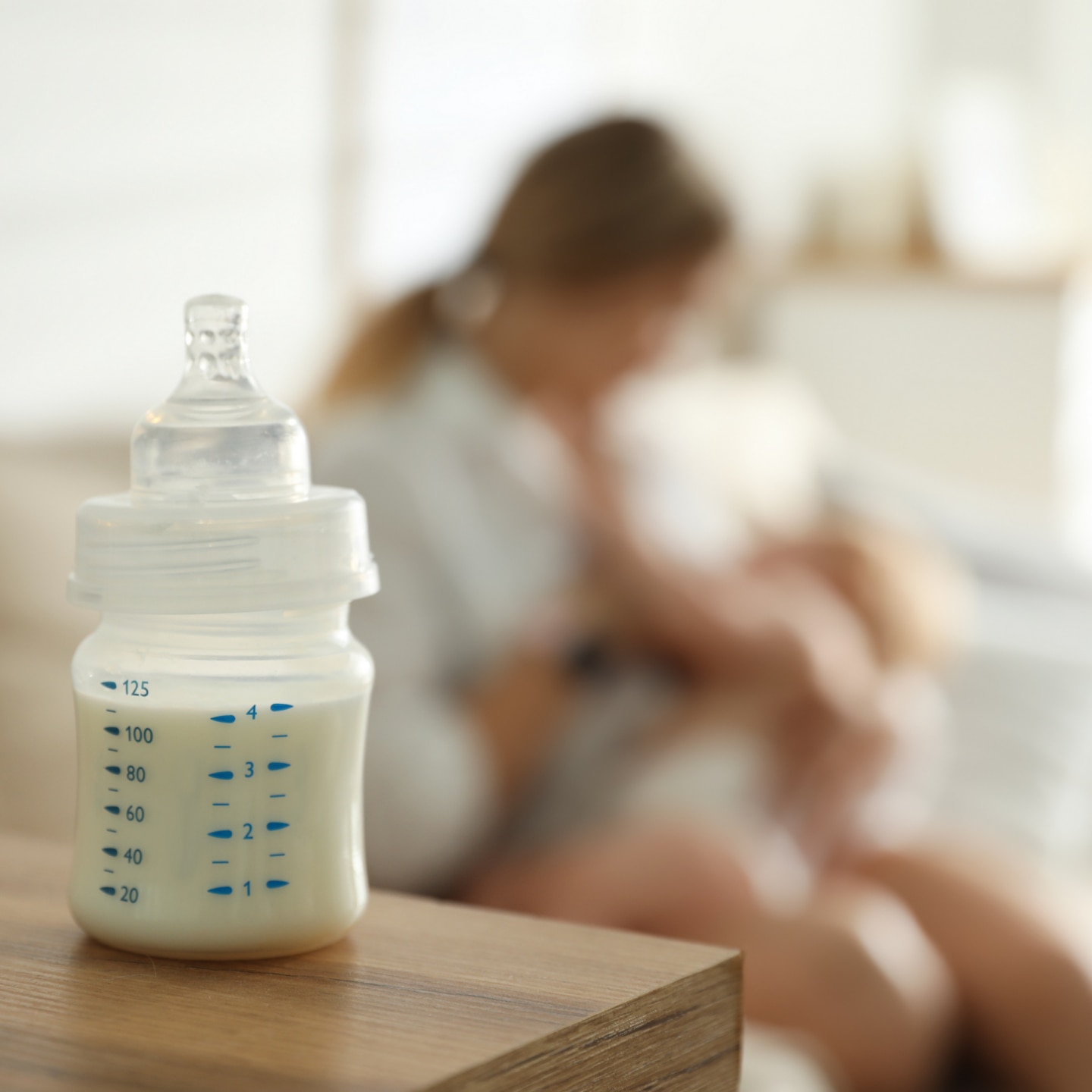Mother breastfeeding her little baby at home