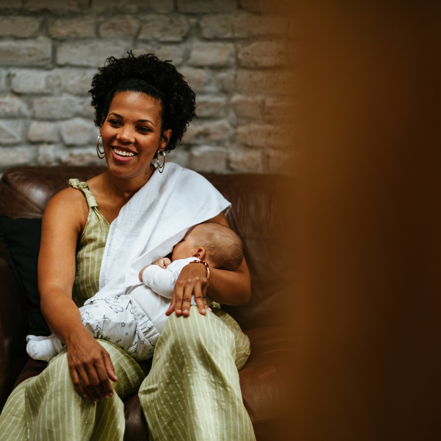 Smiling woman breastfeeding her baby
