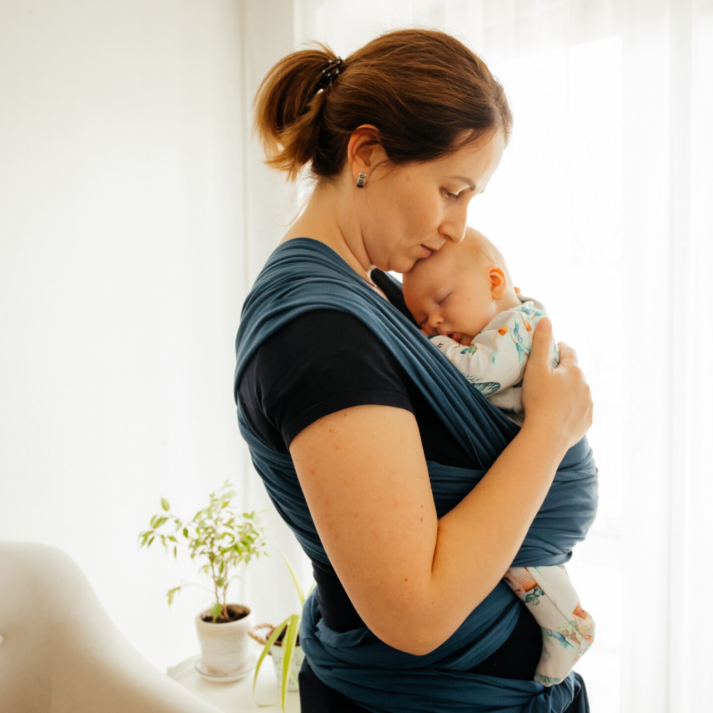 Young mother with baby in sling