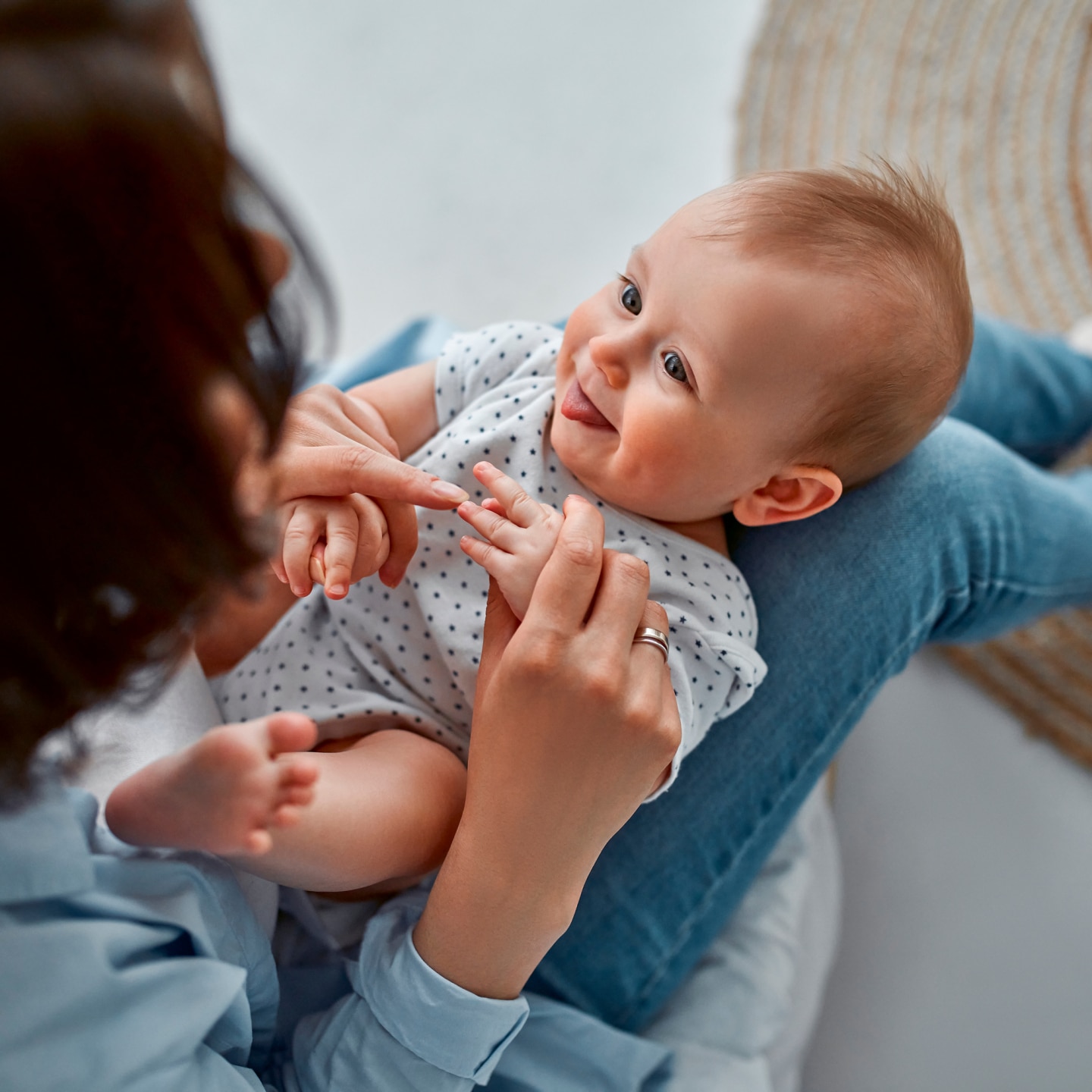 Loving mom carying of her newborn baby at home