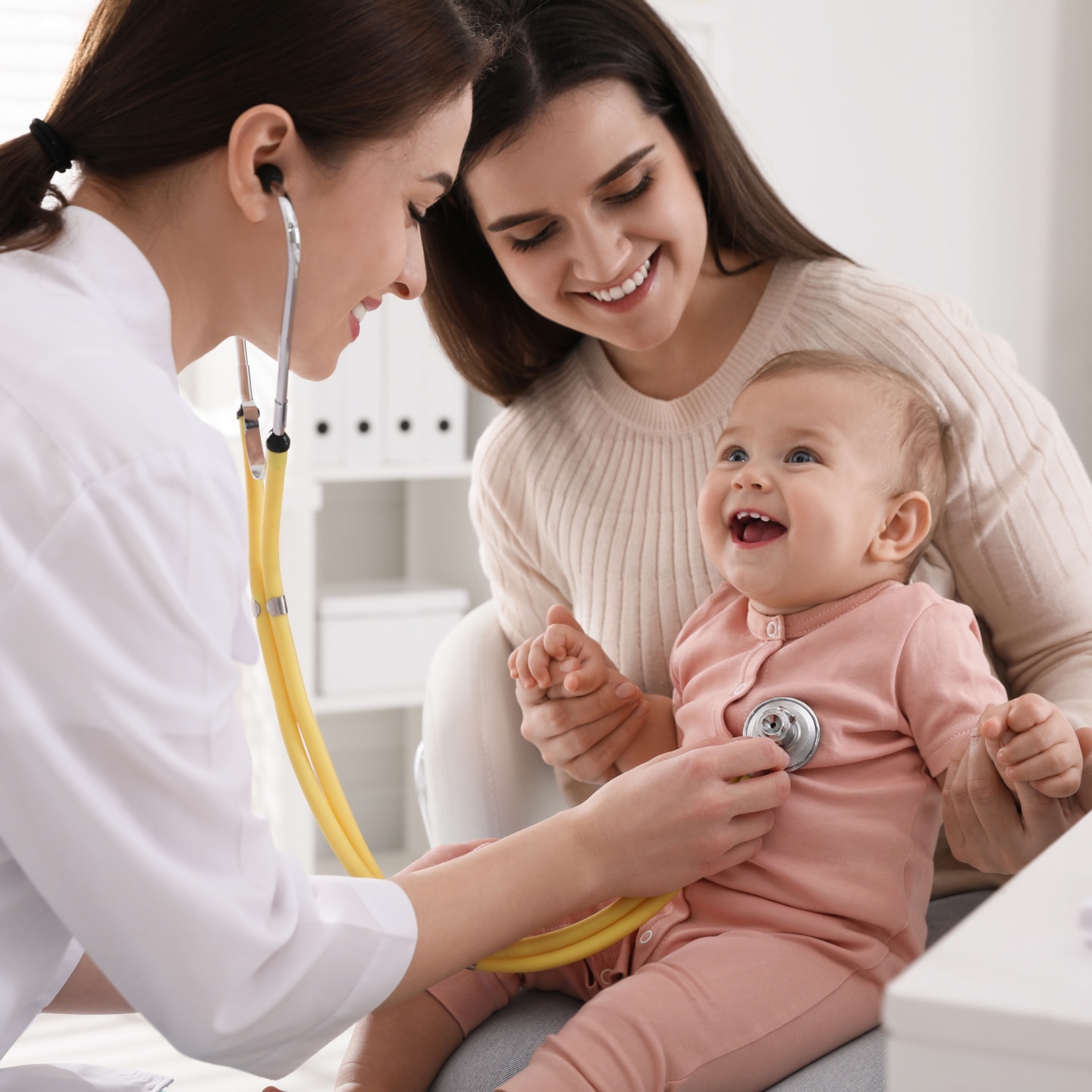 Mother with her cute baby visiting pediatrician in clinic