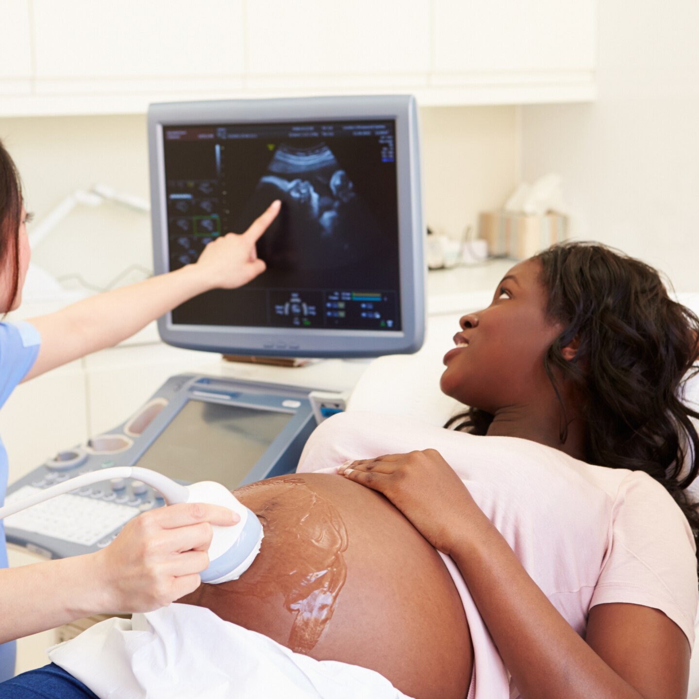 Pregnant Woman And Partner Having 4D Ultrasound Scan