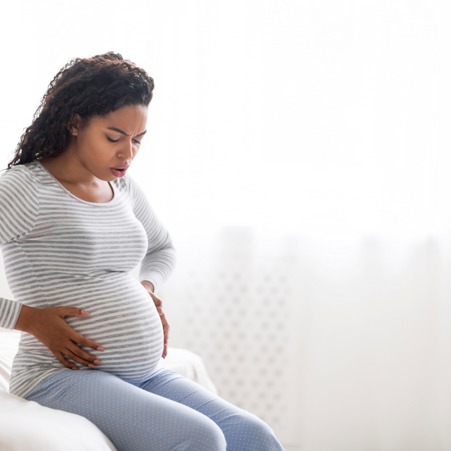 woman suffering abdominal ache at home