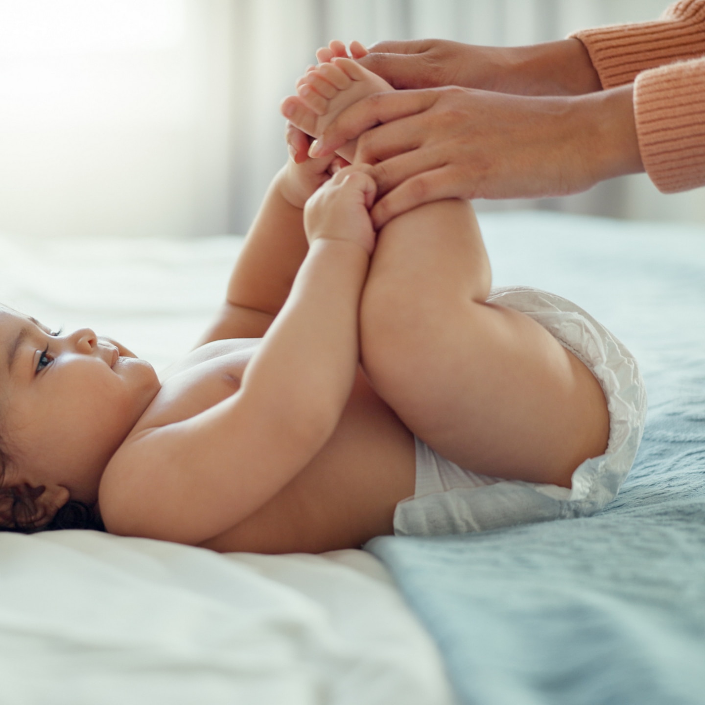 mother with baby on bed