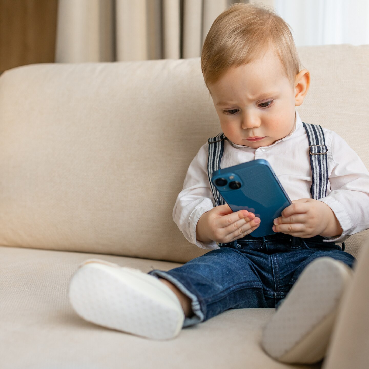 kleinkind-auf-der-couch-am-handy