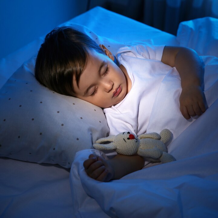 Cute little baby sleeping with toy at home. Bedtime