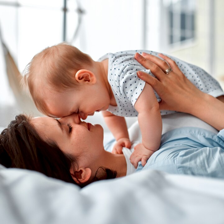 Loving mom carying of her newborn baby at home