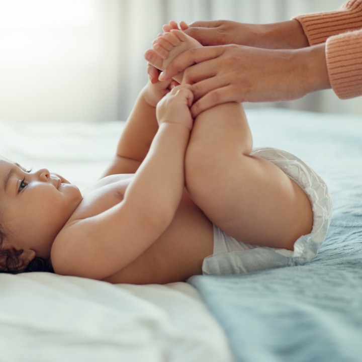 mother with baby on bed