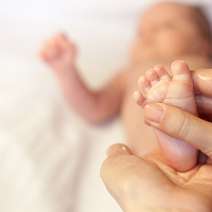 Mother makes massage for happy baby